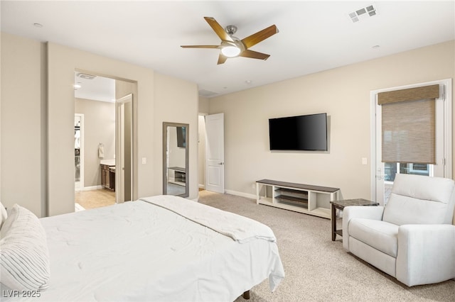 2116 Canvas Edge Dr, Henderson, NV 89044 - bedroom featuring light colored carpet, ensuite bath, a ceiling fan, and baseboards