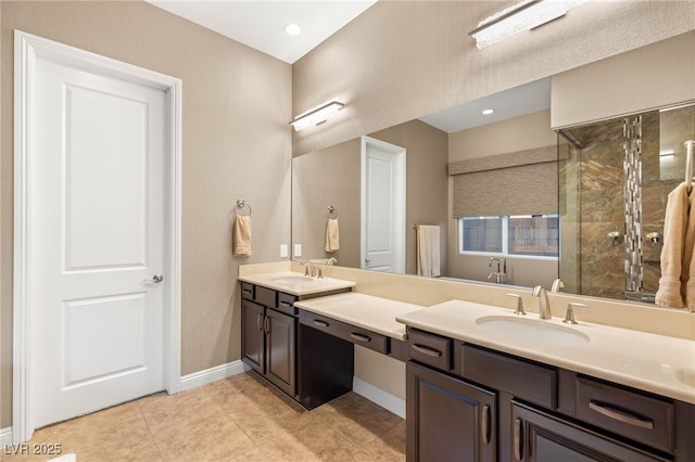 2116 Canvas Edge Dr, Henderson, NV 89044 - bathroom featuring tiled shower, tile patterned floors, baseboards, and double vanity