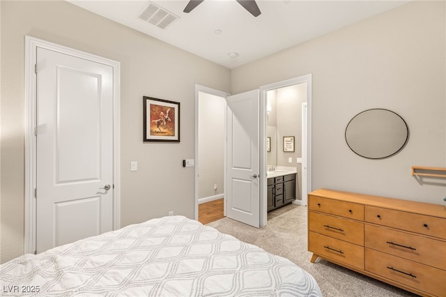 2116 Canvas Edge Dr, Henderson, NV 89044 - bedroom featuring light carpet, baseboards, ensuite bathroom, ceiling fan, and a sink