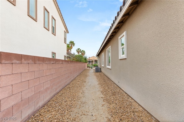 2116 Canvas Edge Dr, Henderson, NV 89044 - view of home's exterior with stucco siding, fence, and cooling unit