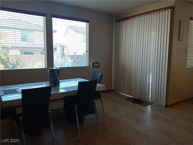 dining space featuring healthy amount of natural light and tile patterned floors