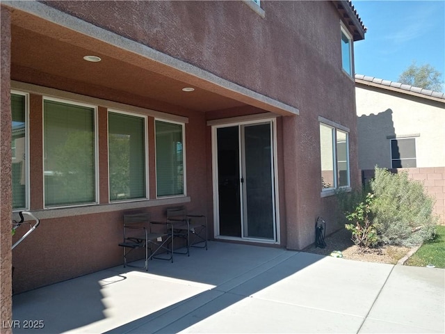 back of house featuring a patio and stucco siding