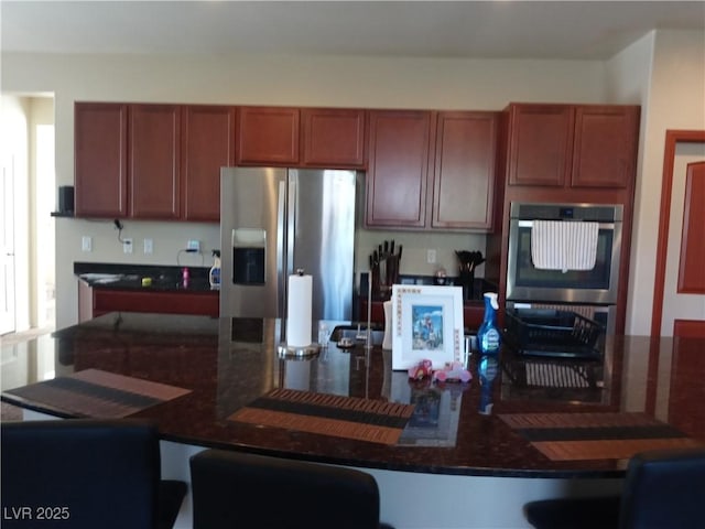 kitchen featuring stainless steel appliances and a kitchen bar