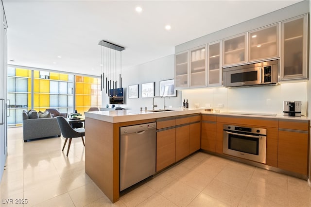 3726 Las Vegas Blvd Unit 2410, Las Vegas, NV 89158 - kitchen with stainless steel appliances, a peninsula, open floor plan, light countertops, and a sink