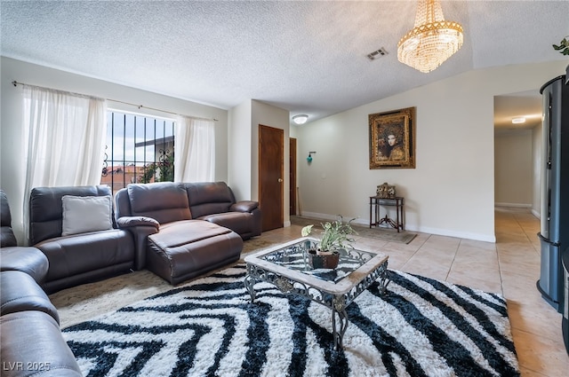 living room with a textured ceiling, light tile patterned floors, and a chandelier