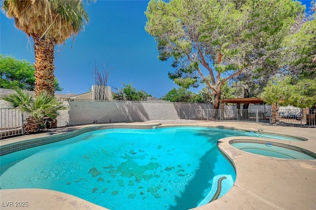 view of pool featuring an in-ground hot tub and a fenced backyard