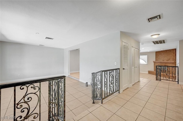 corridor with light tile patterned floors and baseboards