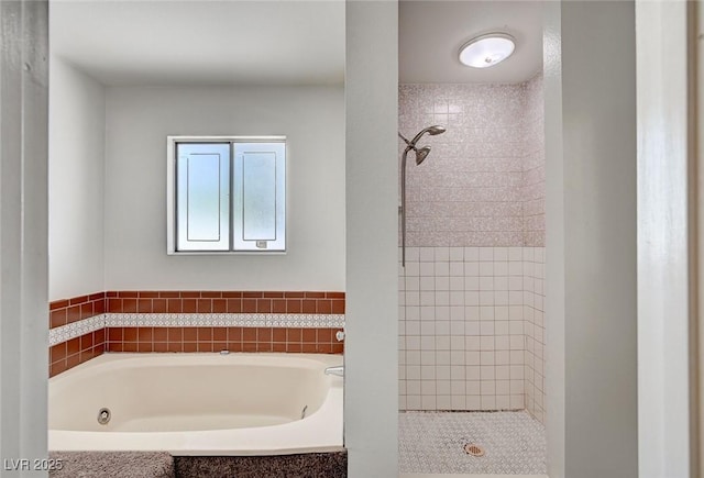 bathroom featuring a stall shower and a garden tub