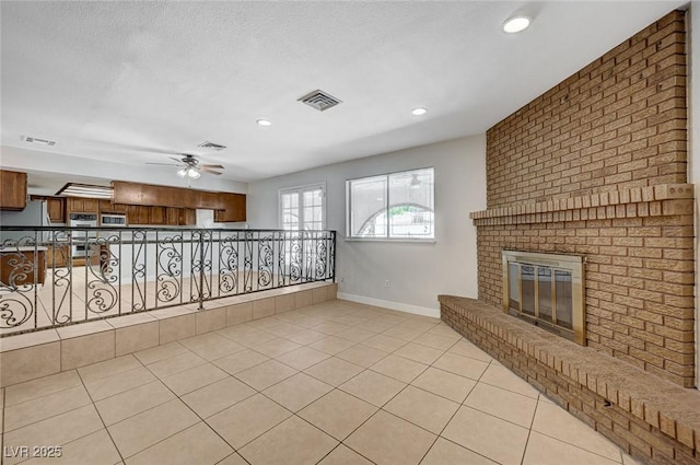 unfurnished living room featuring baseboards, ceiling fan, light tile patterned flooring, a fireplace, and recessed lighting
