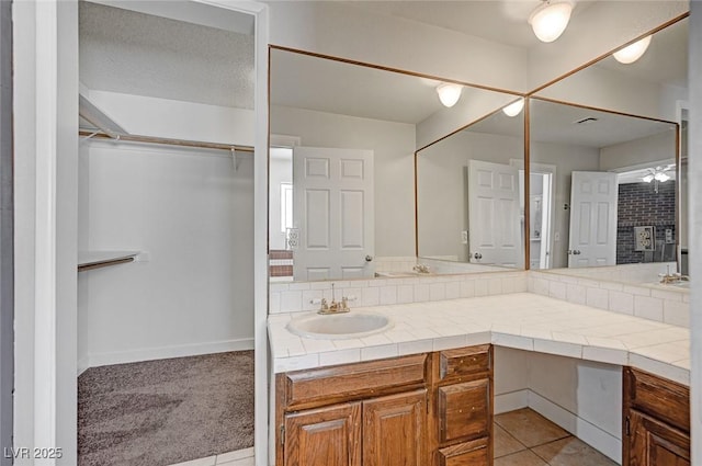full bath featuring vanity and a spacious closet