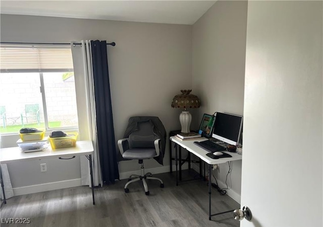 home office featuring wood finished floors and baseboards