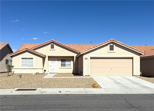 single story home with stucco siding, an attached garage, concrete driveway, and a tiled roof