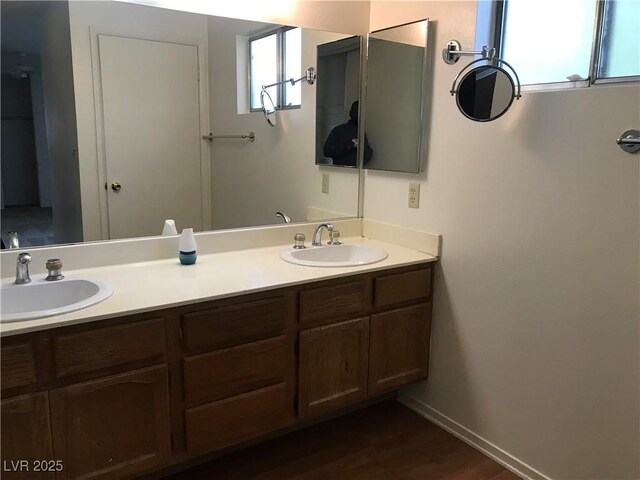 3138 White Rose Way, Henderson, NV 89014 - bathroom featuring double vanity, wood finished floors, and baseboards