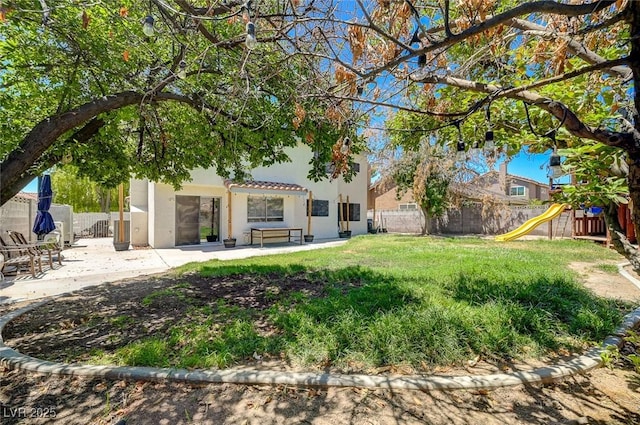 3138 White Rose Way, Henderson, NV 89014 - fenced backyard with a playground and a patio area