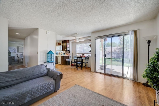 3138 White Rose Way, Henderson, NV 89014 - living area with wood finished floors, a textured ceiling, and a ceiling fan