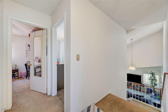 3138 White Rose Way, Henderson, NV 89014 - hall with a textured ceiling, an upstairs landing, and light colored carpet