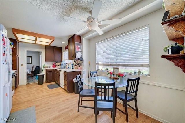 3138 White Rose Way, Henderson, NV 89014 - dining space with ceiling fan, light wood finished floors, and a textured ceiling