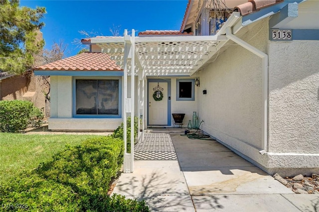 3138 White Rose Way, Henderson, NV 89014 - property entrance with stucco siding, a tiled roof, and a pergola