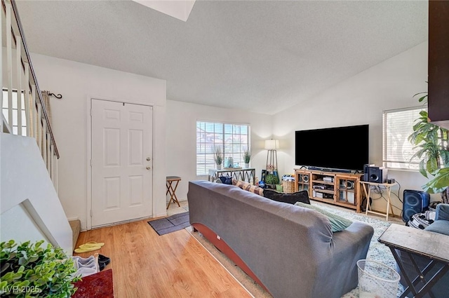 3138 White Rose Way, Henderson, NV 89014 - living area featuring light wood finished floors, lofted ceiling, and a textured ceiling