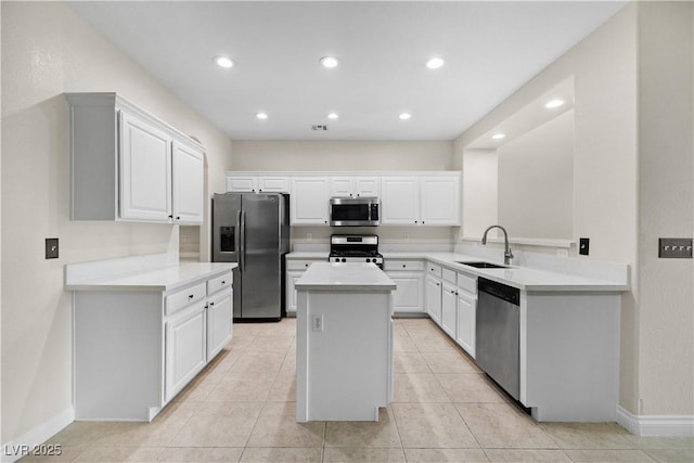 258 Chamomile Dr, Henderson, NV 89015 - kitchen with appliances with stainless steel finishes, a sink, a kitchen island, baseboards, and light countertops