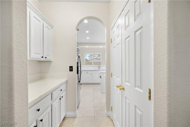258 Chamomile Dr, Henderson, NV 89015 - hall featuring light tile patterned floors, arched walkways, a sink, and recessed lighting