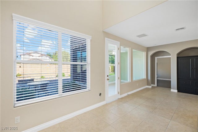 258 Chamomile Dr, Henderson, NV 89015 - spare room featuring baseboards, light tile patterned floors, and arched walkways