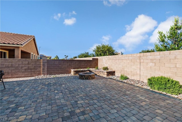 258 Chamomile Dr, Henderson, NV 89015 - view of patio / terrace with a fire pit and a fenced backyard