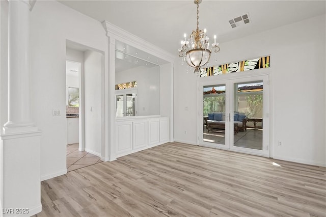 253 White Willow Ave, Las Vegas, NV 89123 - unfurnished dining area featuring wood finished floors, decorative columns, a chandelier, and baseboards
