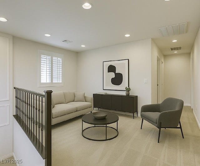 living area with recessed lighting, baseboards, and light colored carpet
