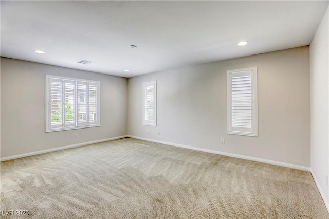 carpeted spare room with baseboards and recessed lighting