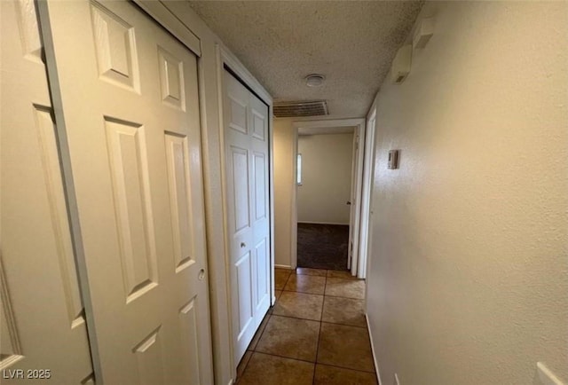 101 Luna Way Unit 145, Las Vegas, NV 89145 - hall with a textured ceiling and dark tile patterned floors