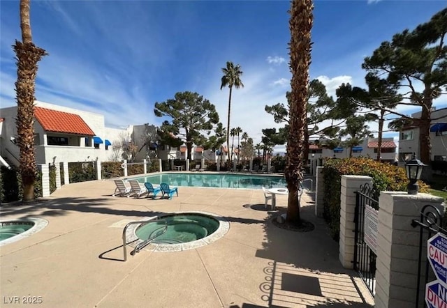 101 Luna Way Unit 145, Las Vegas, NV 89145 - community pool featuring a hot tub, a patio area, and fence