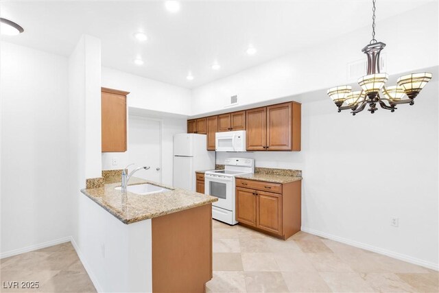 2615 W Gary Ave Unit 1041, Las Vegas, NV 89123 - kitchen featuring white appliances, a sink, a chandelier, a peninsula, and light stone counters