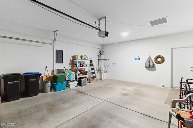 garage featuring electric panel and a garage door opener