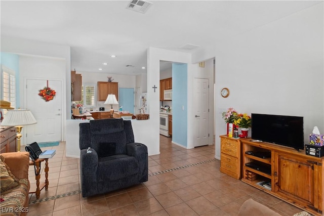 living area with light tile patterned flooring and recessed lighting