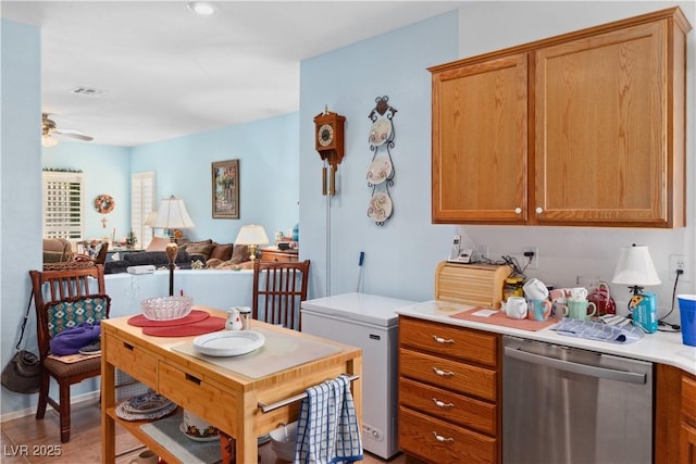 kitchen featuring dishwasher, ceiling fan, open floor plan, light countertops, and brown cabinets