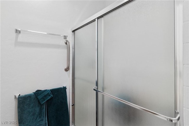 bathroom with a shower with shower door