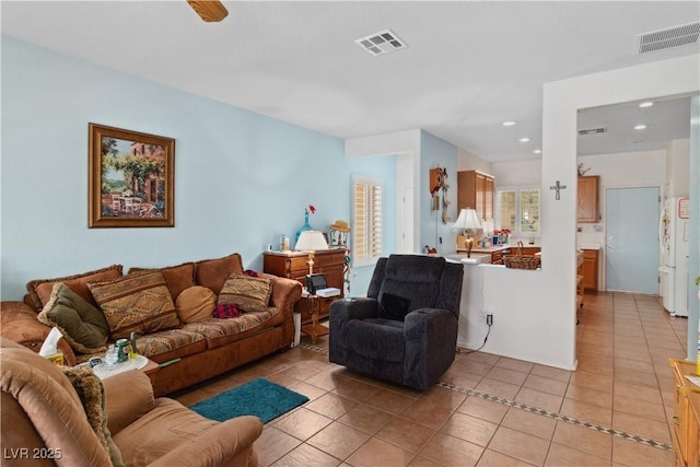living area with light tile patterned flooring and recessed lighting