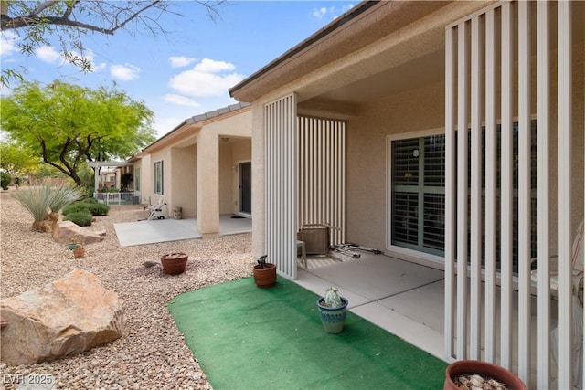back of property featuring stucco siding and a patio area