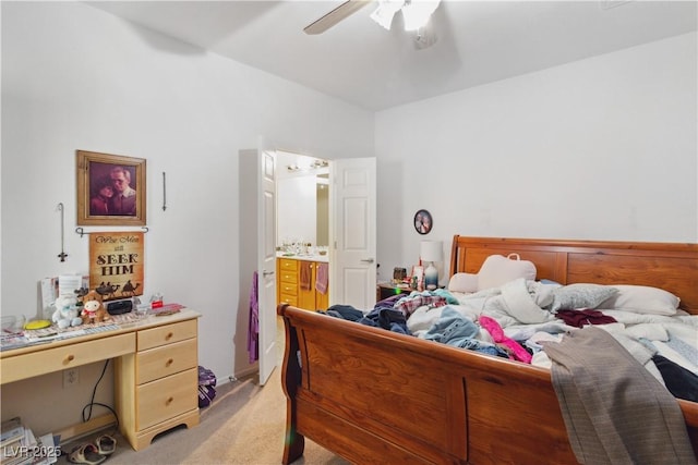 bedroom with light carpet, connected bathroom, and ceiling fan