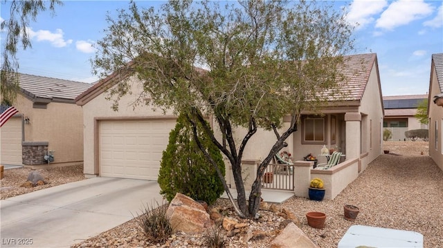 view of front of house with stucco siding and concrete driveway