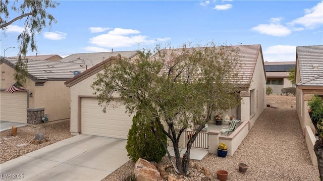 view of front facade with stucco siding, driveway, and a garage