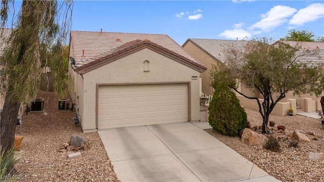 view of front facade with stucco siding, a tiled roof, concrete driveway, and central AC
