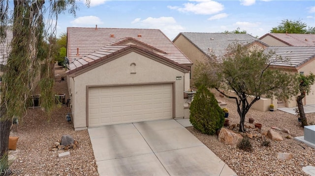 view of front facade with stucco siding, a tile roof, and driveway