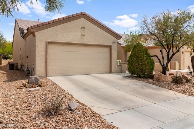 view of front of home featuring stucco siding, a tile roof, central AC unit, driveway, and an attached garage