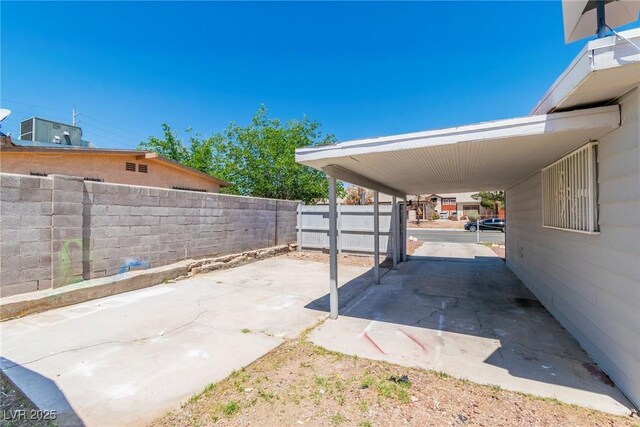 view of patio / terrace with fence and an attached carport
