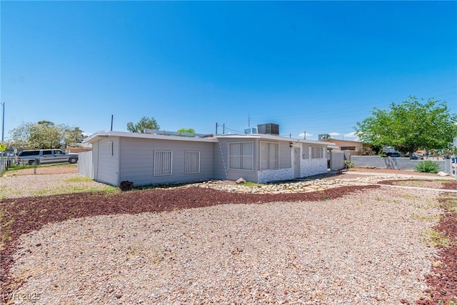 rear view of house with fence