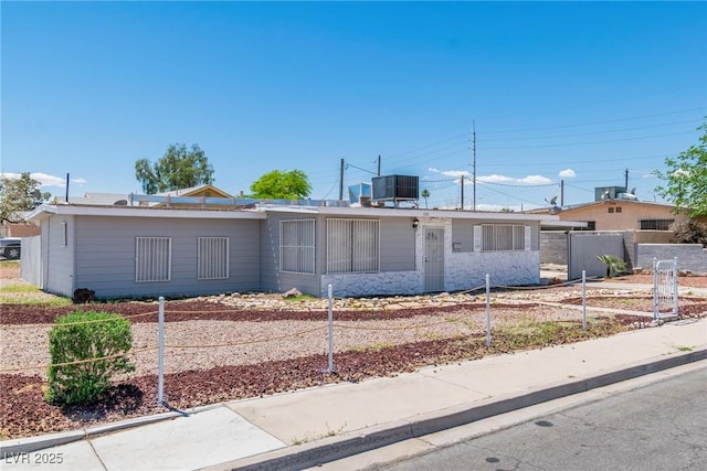 single story home featuring fence and central air condition unit