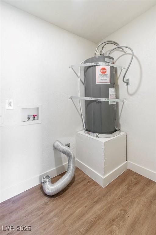 laundry room with water heater, baseboards, wood finished floors, and hookup for a washing machine