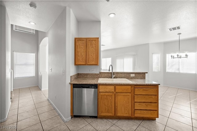 2333 Silver Crew Pass, Henderson, NV 89052 - kitchen with dishwasher, a sink, a textured ceiling, light tile patterned floors, and brown cabinetry
